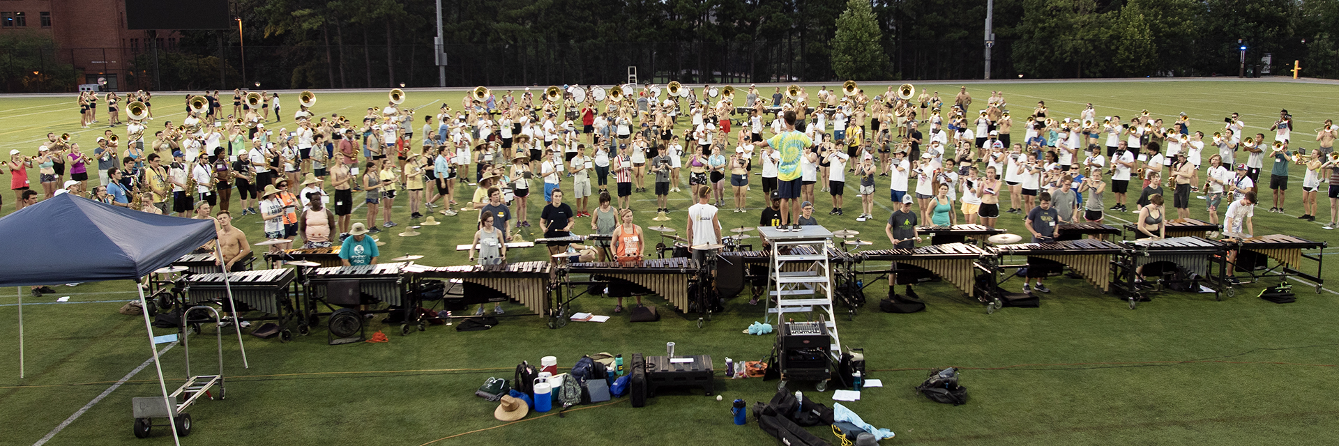 Students outside on a field at band camp.