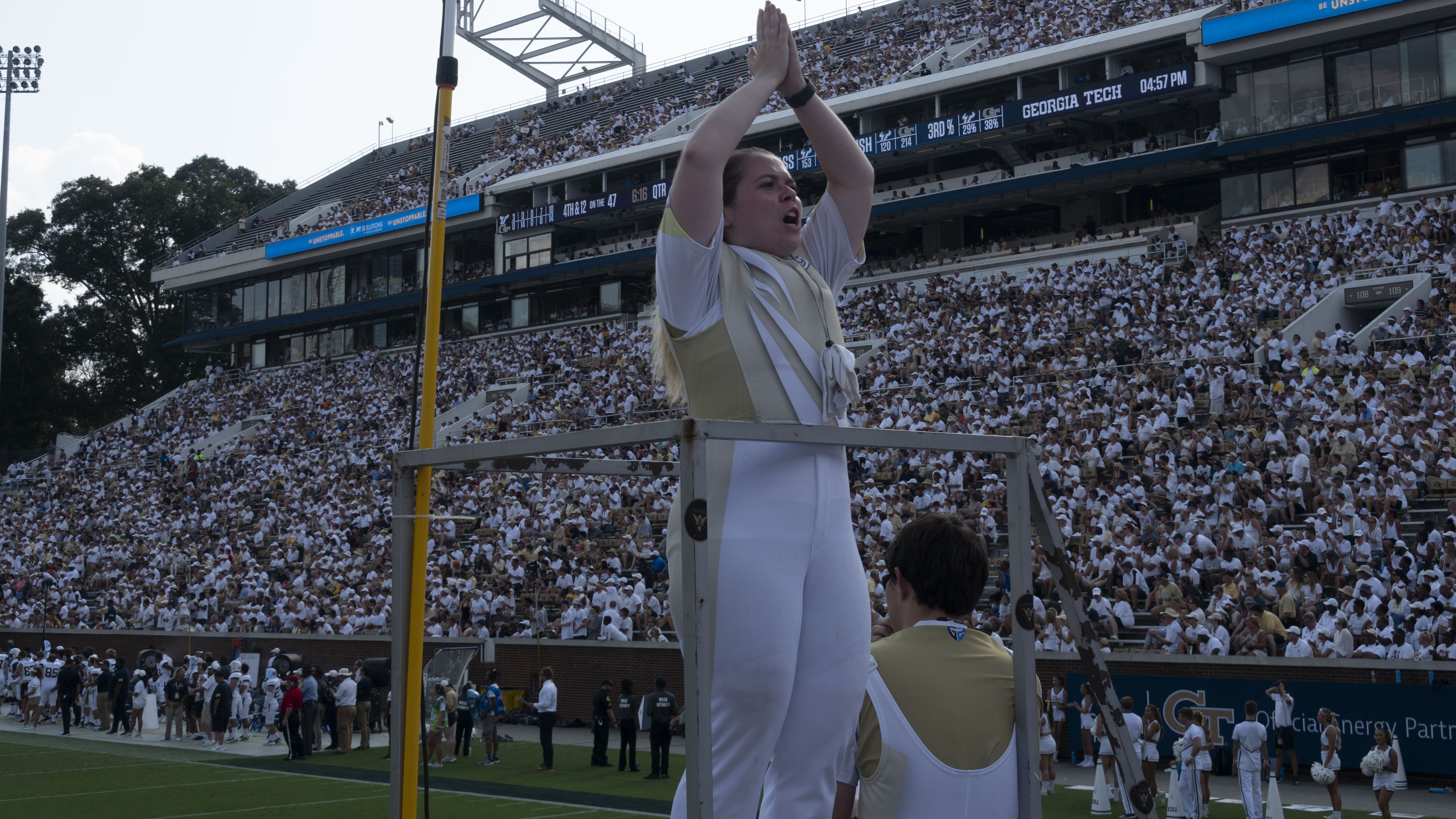 A drum major leading the band at a game.