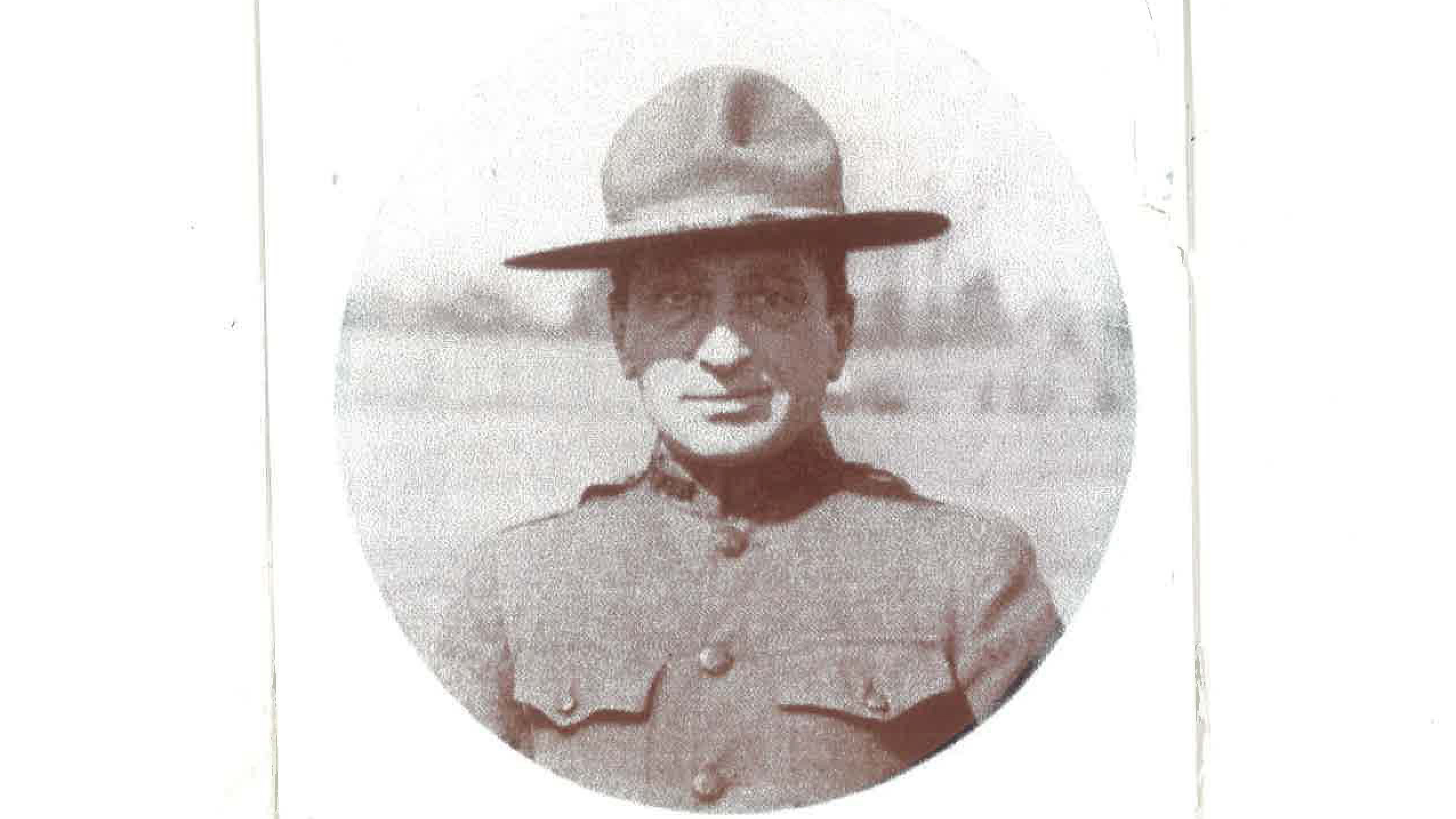 A close up of Frank Roman, wearing a military style hat.