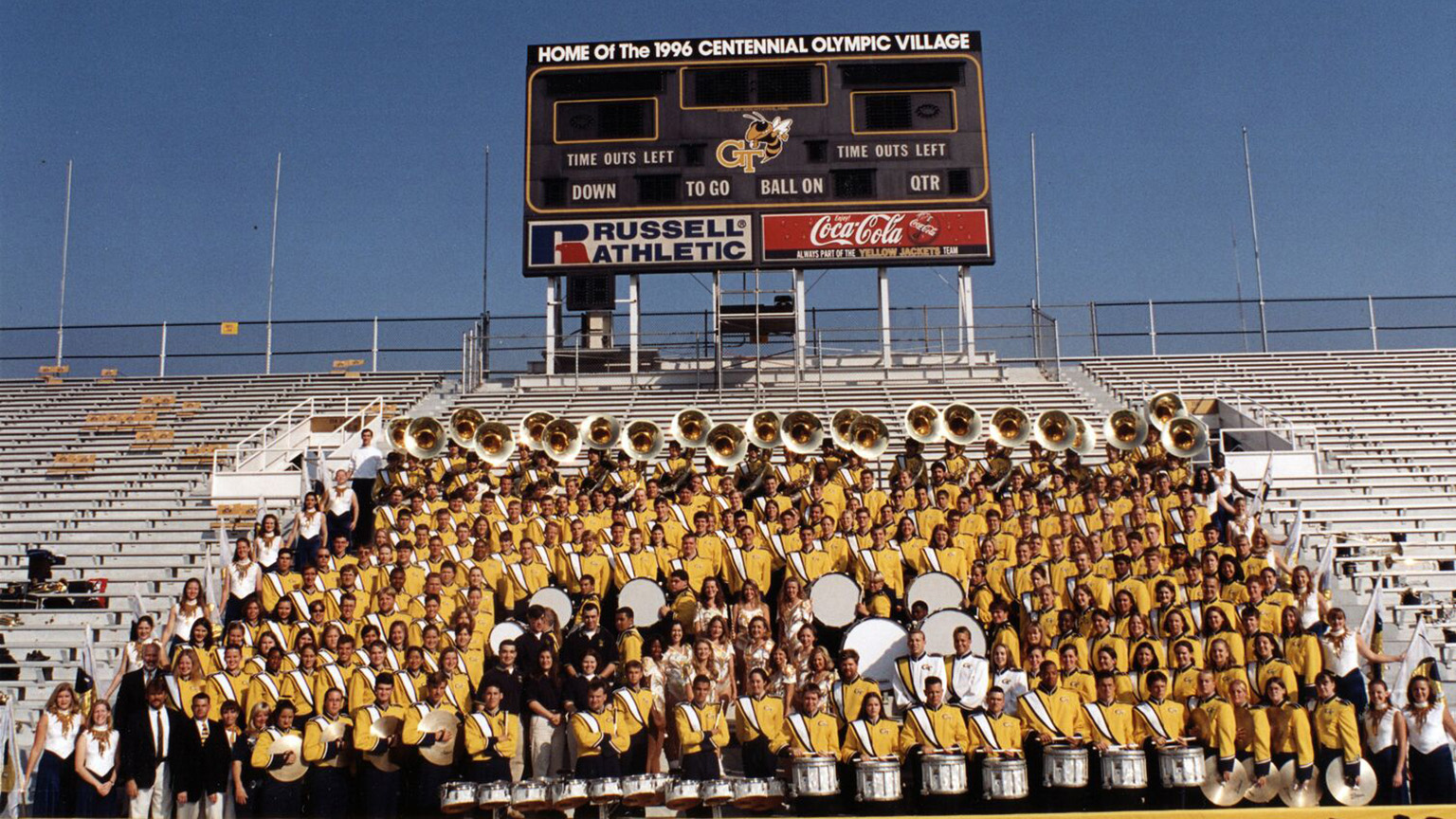 A shot of the 1996 Marching Band posing in the bleachers.