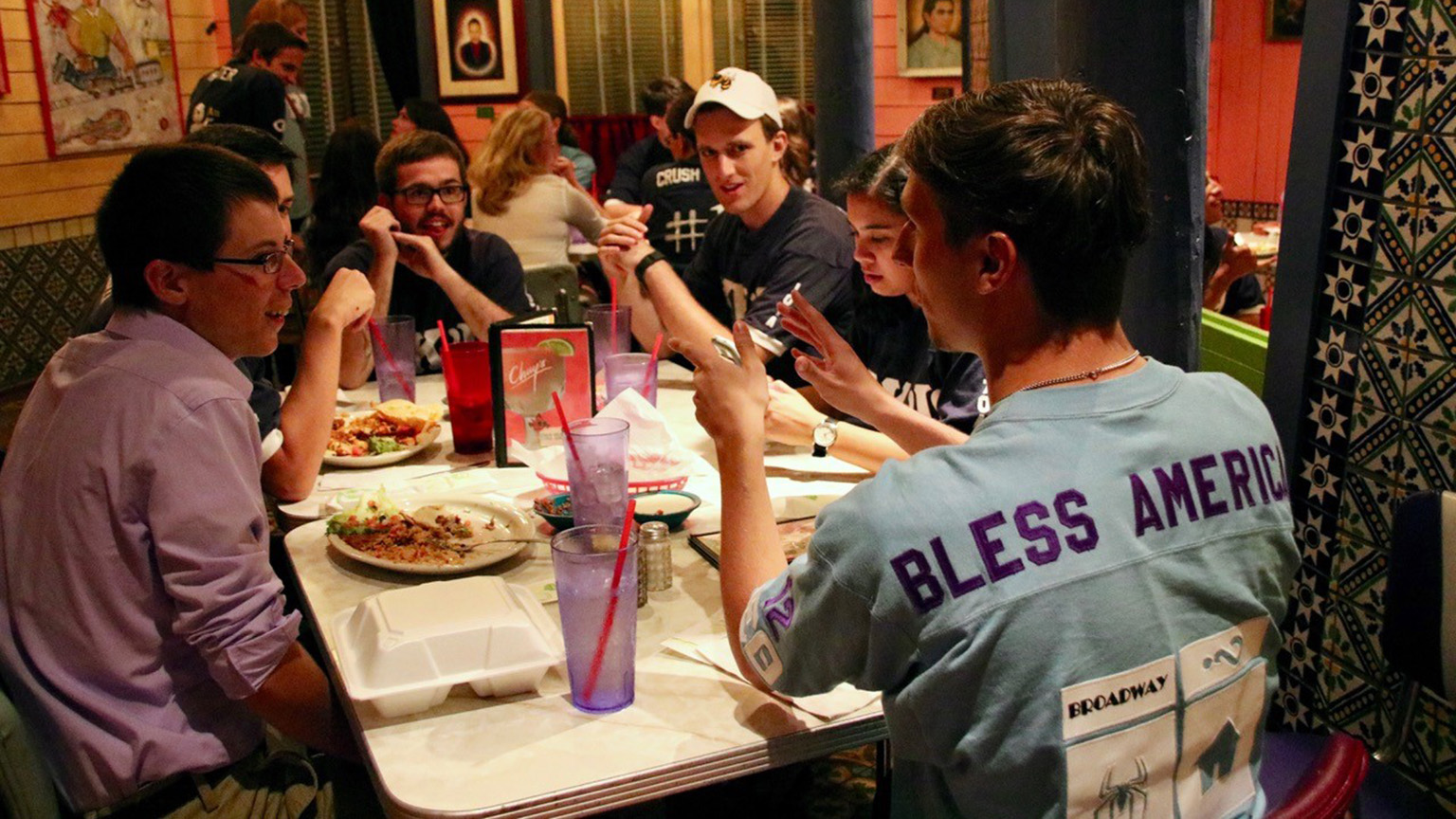 A group of band students eating at a restaurant.