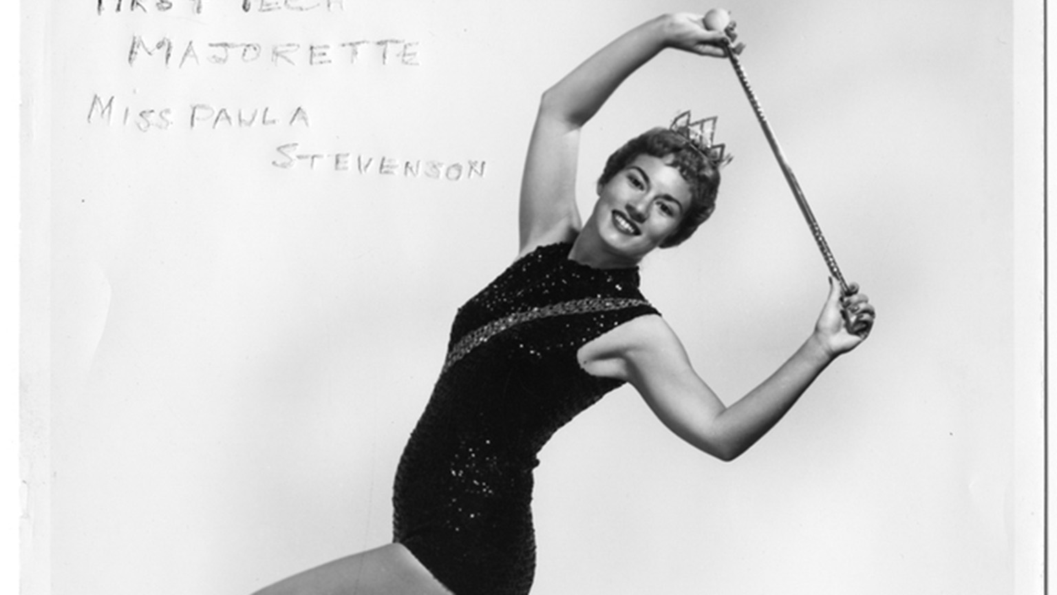 Paula Stevenson, the band's first majorette, poses with a baton.