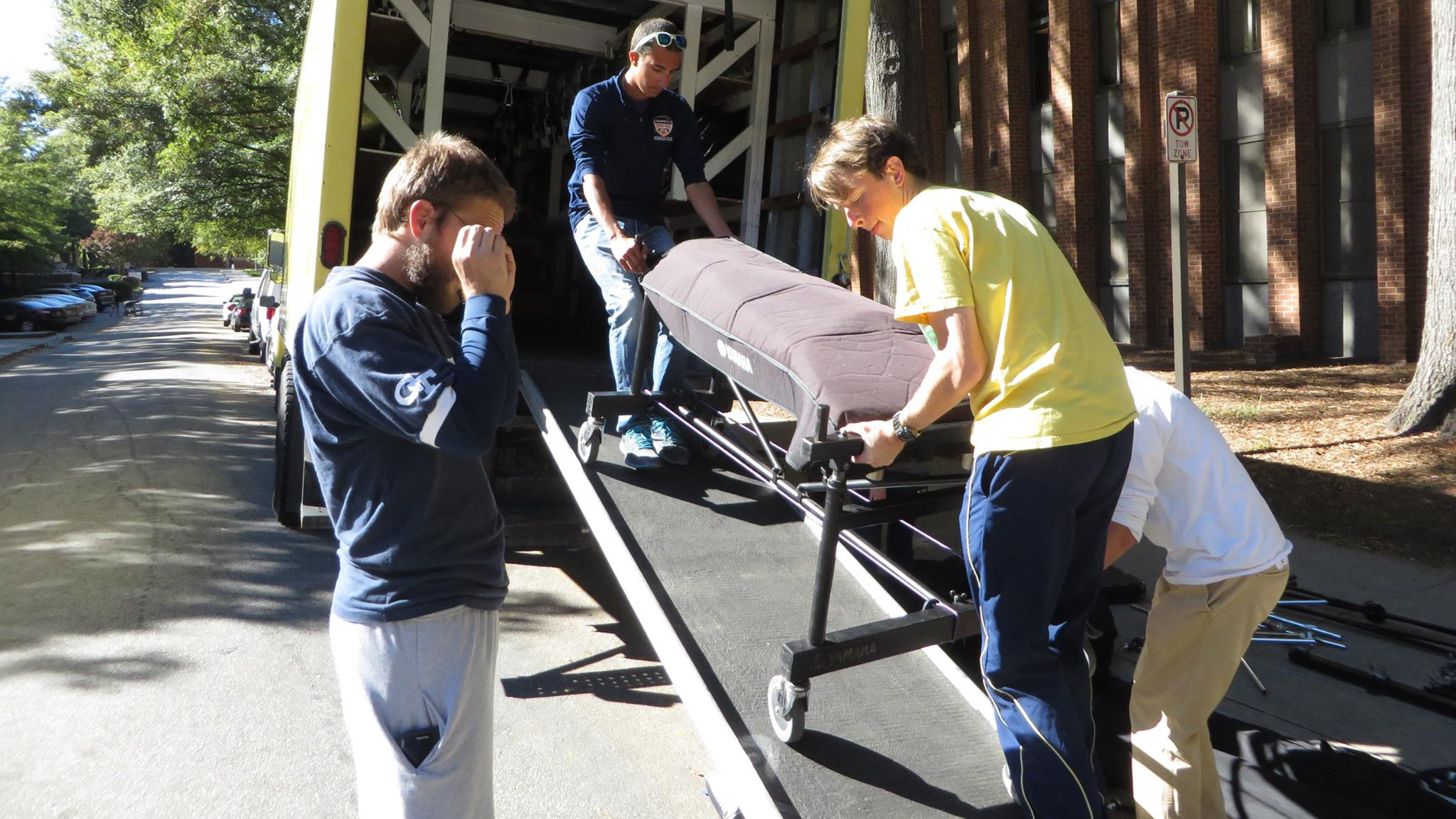 A group of students unloading a marimba after a gig.