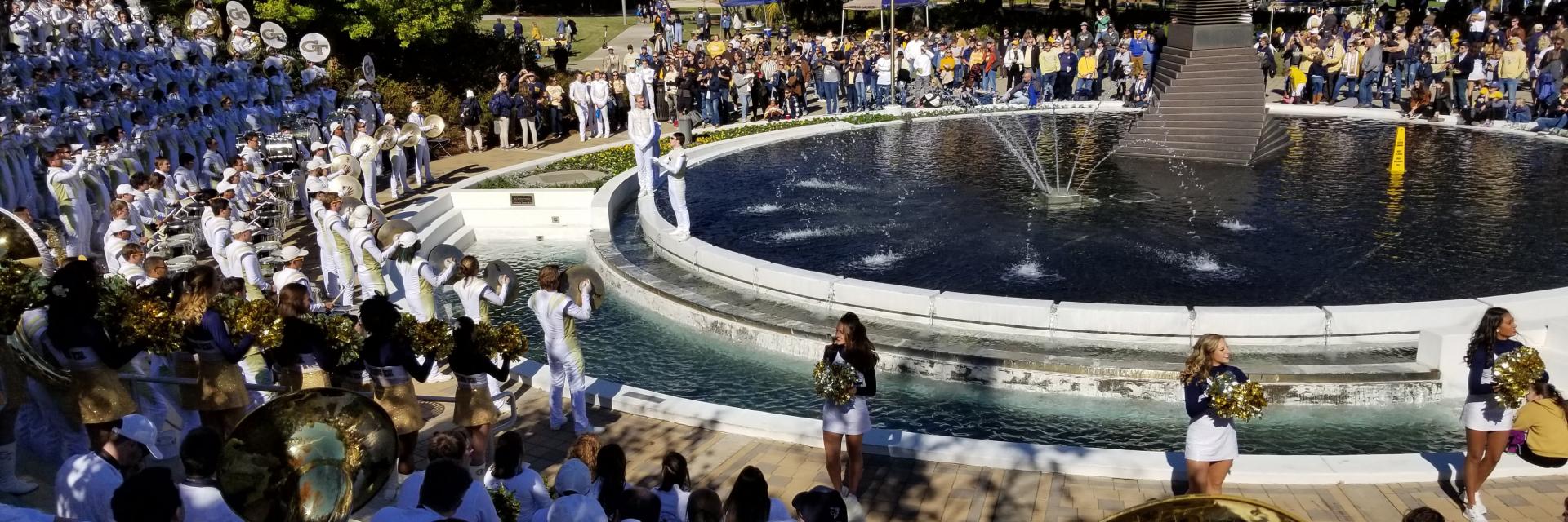 The Marching Band performing around the Campanile fountain.