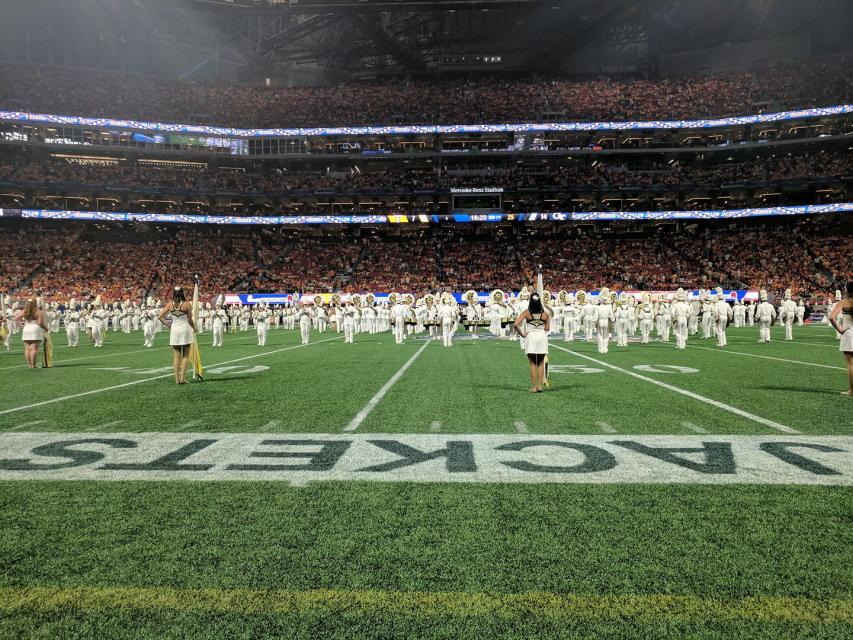 Yellow Jacket Marching Band performs on field at Mercedes Benz Stadium